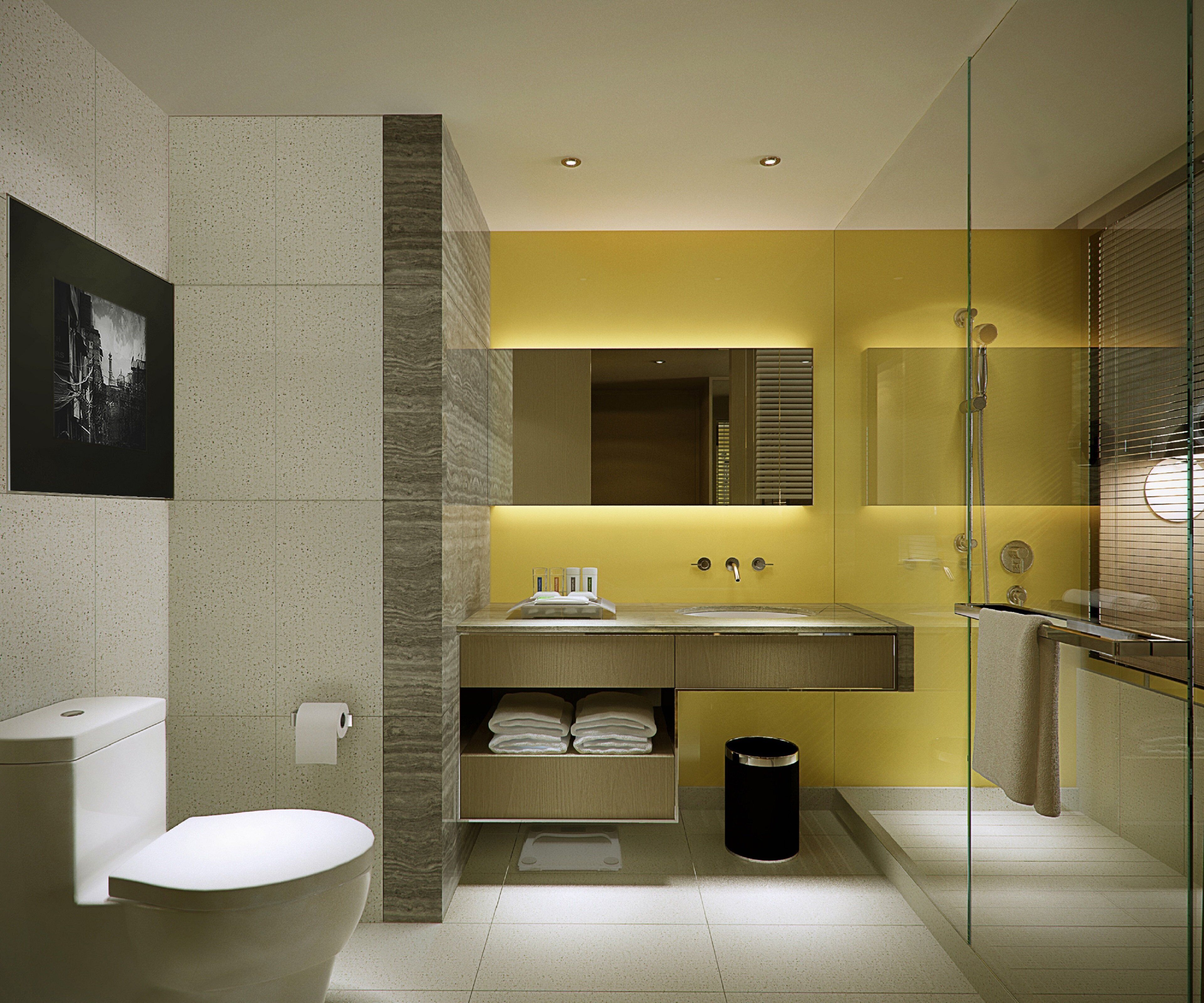 A modern bathroom with a toilet, sink, and shower area.