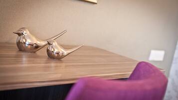 A wooden table with two metallic bird-shaped sculptures.