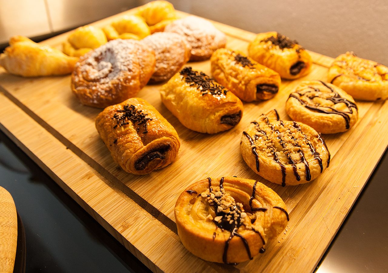 A variety of pastries on a wooden board.