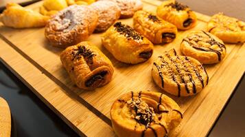 A variety of pastries on a wooden board.