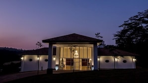 Una casa moderna con una amplia entrada de vidrio y un patio cubierto.