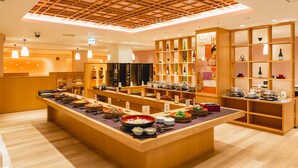 A buffet area with various food stations and a wooden ceiling. - Arima Kirari (Kobe)