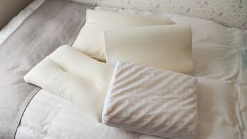 A bed with white bedding and a patterned wall.
