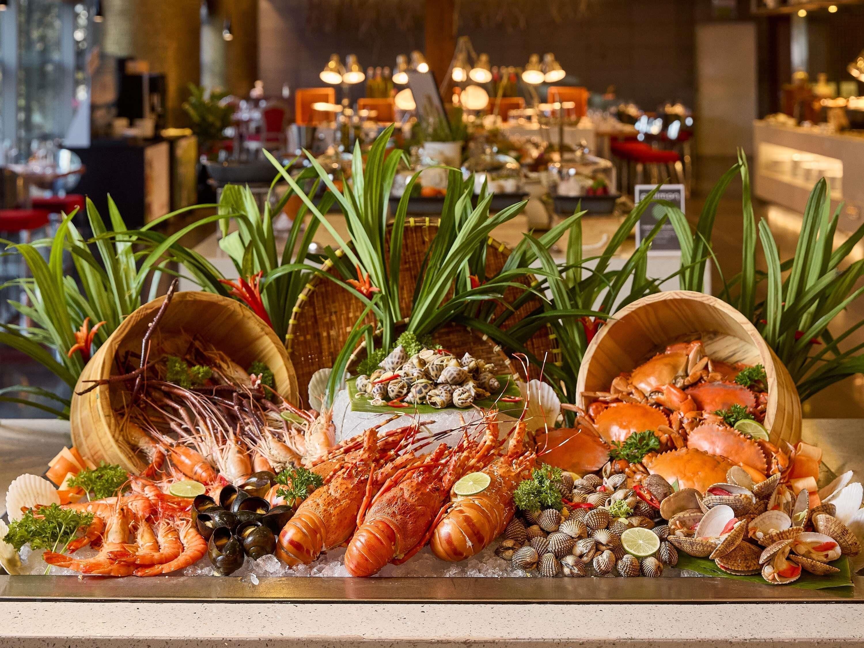 A seafood platter with various shellfish and lobsters on ice.