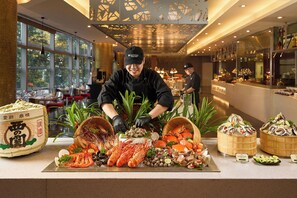 A seafood buffet with various types of seafood displayed on a counter. - Pullman Saigon Centre (Ho Chi Minh City)