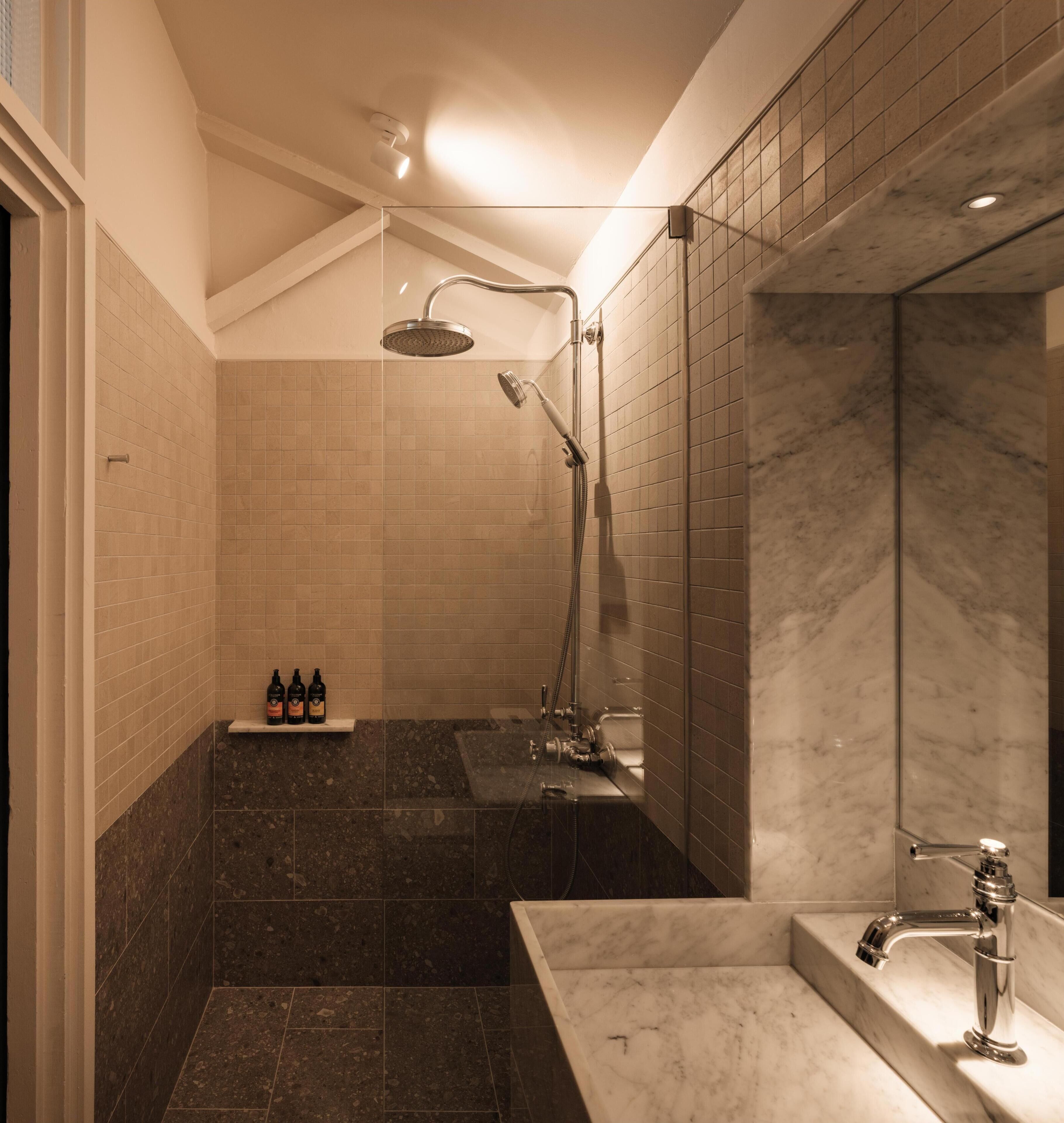 mews standard room | bathroom | shower, free toiletries, hair dryer, slippers