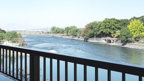 A river with a bridge and trees on the banks. - Seizansou (Uji)