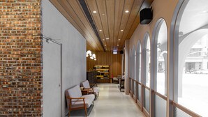 A modern interior with a brick wall, wooden ceiling, and large windows. - inns hotel (Kaohsiung)