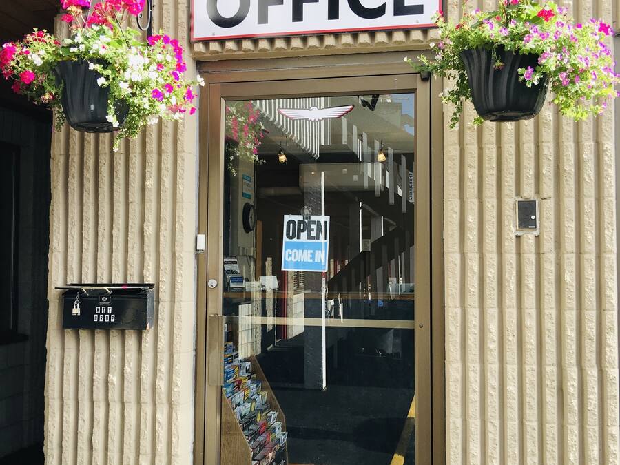 An office building entrance with a sign reading "OFFICE" and a wheelchair accessibility sign.