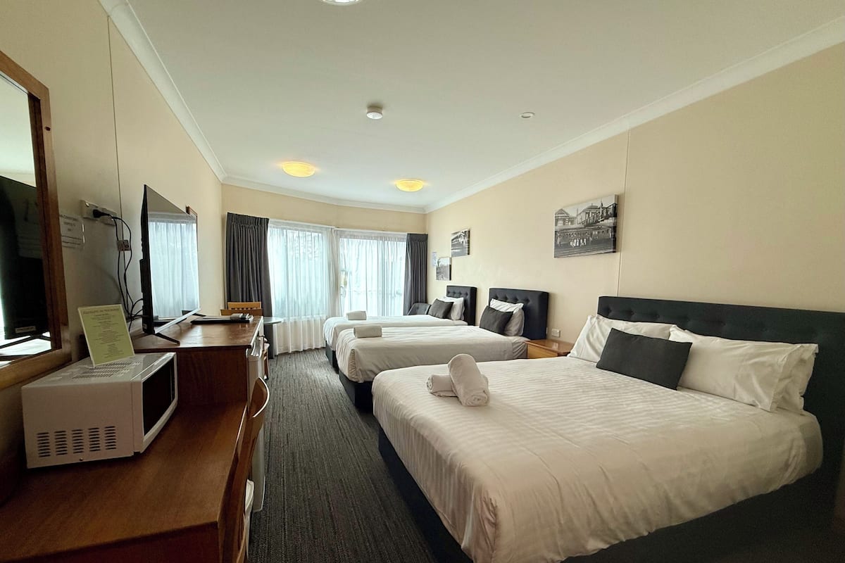 Deluxe Quadruple Room | Premium bedding, pillowtop beds, desk, laptop workspace