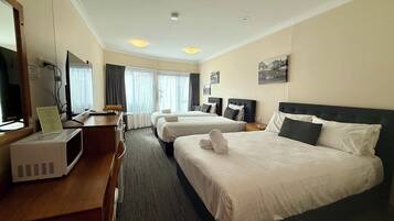 Deluxe Quadruple Room | Premium bedding, pillow-top beds, desk, laptop workspace