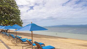 On the beach, sun-loungers, beach towels, kayaking