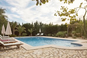 Outdoor pool, open 11:00 AM to 8:00 PM, pool loungers