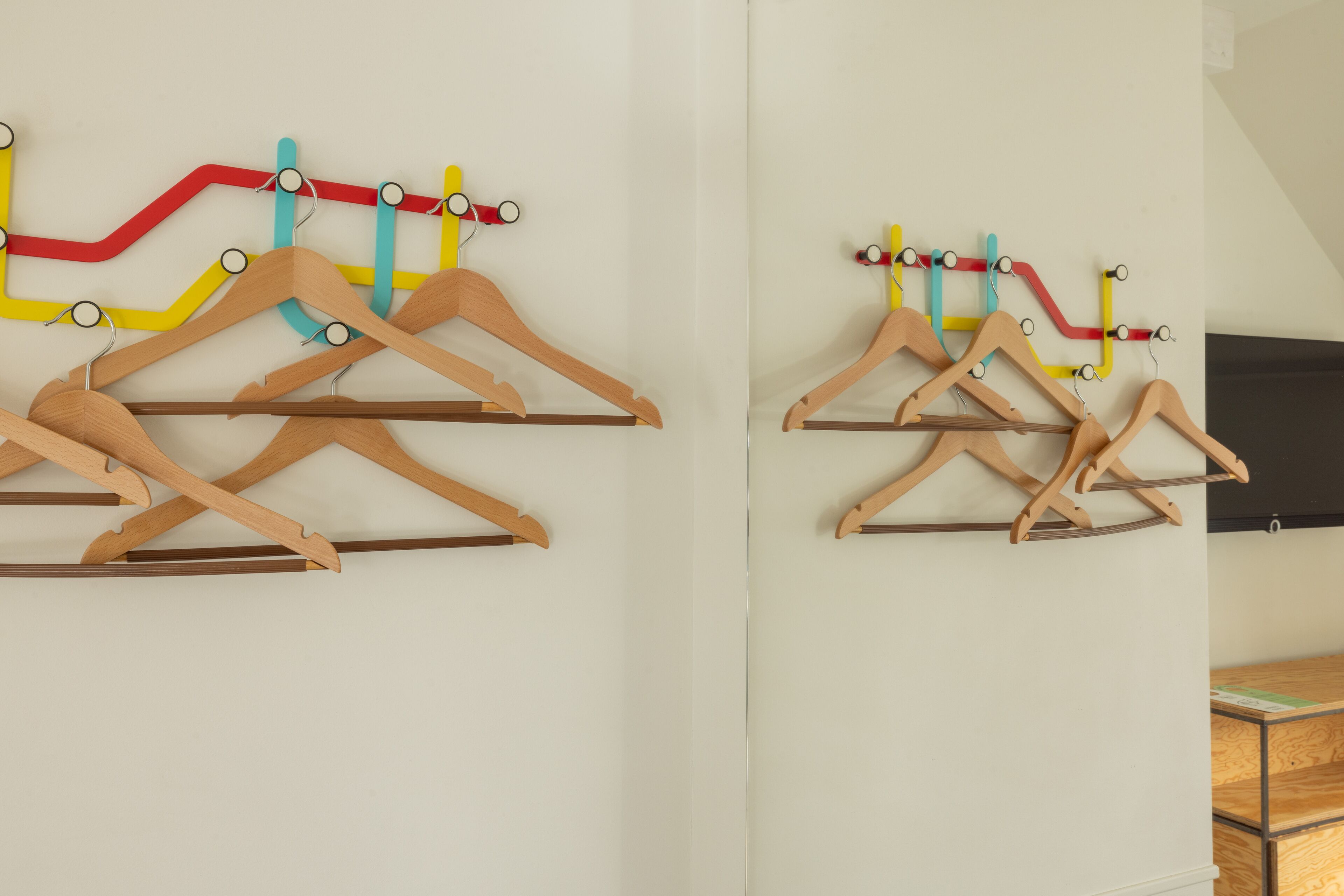 A wall with wooden hangers arranged in a pattern.