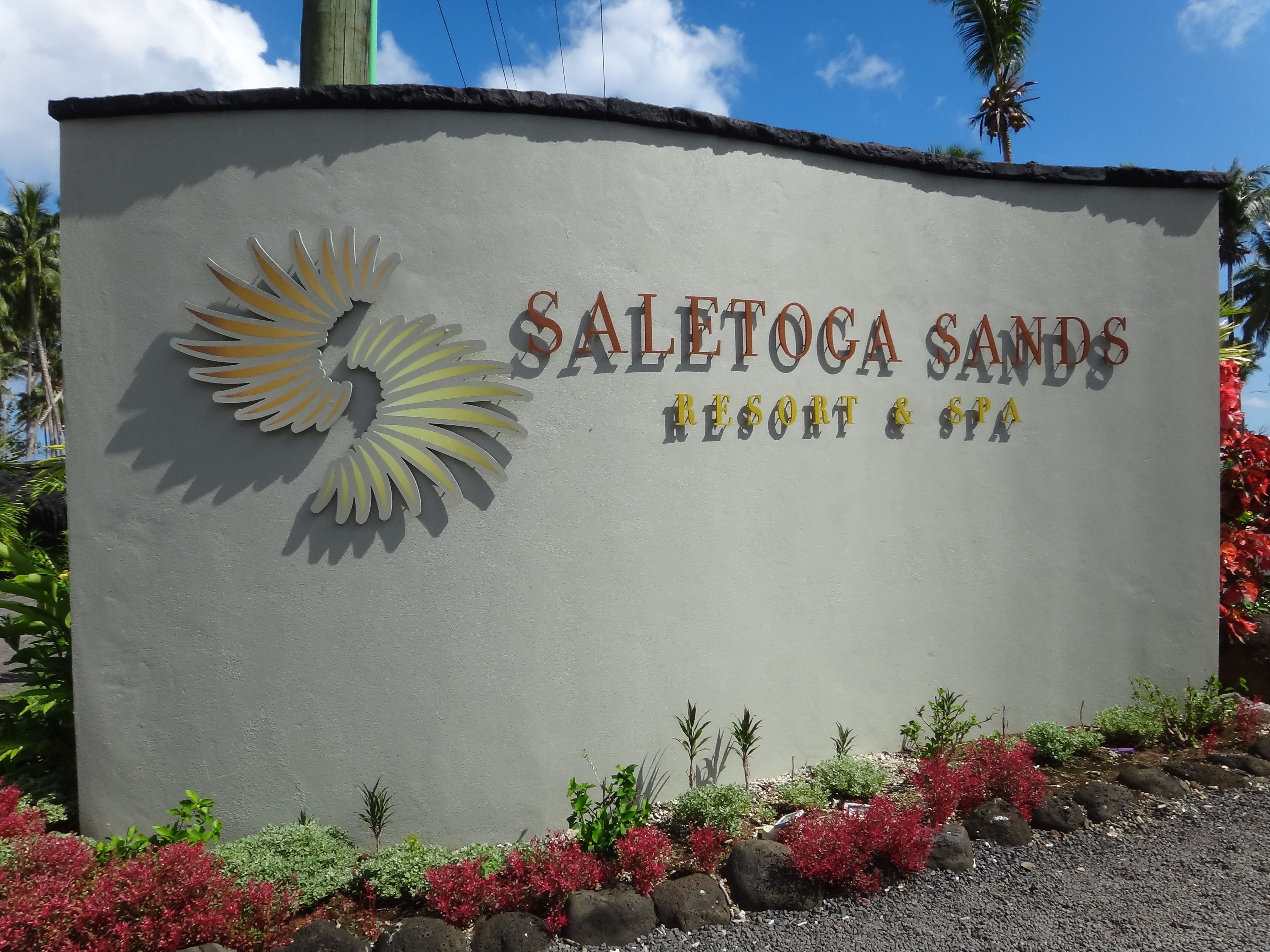A sign for Saletoca Sands Resort & Spa with a sun logo.