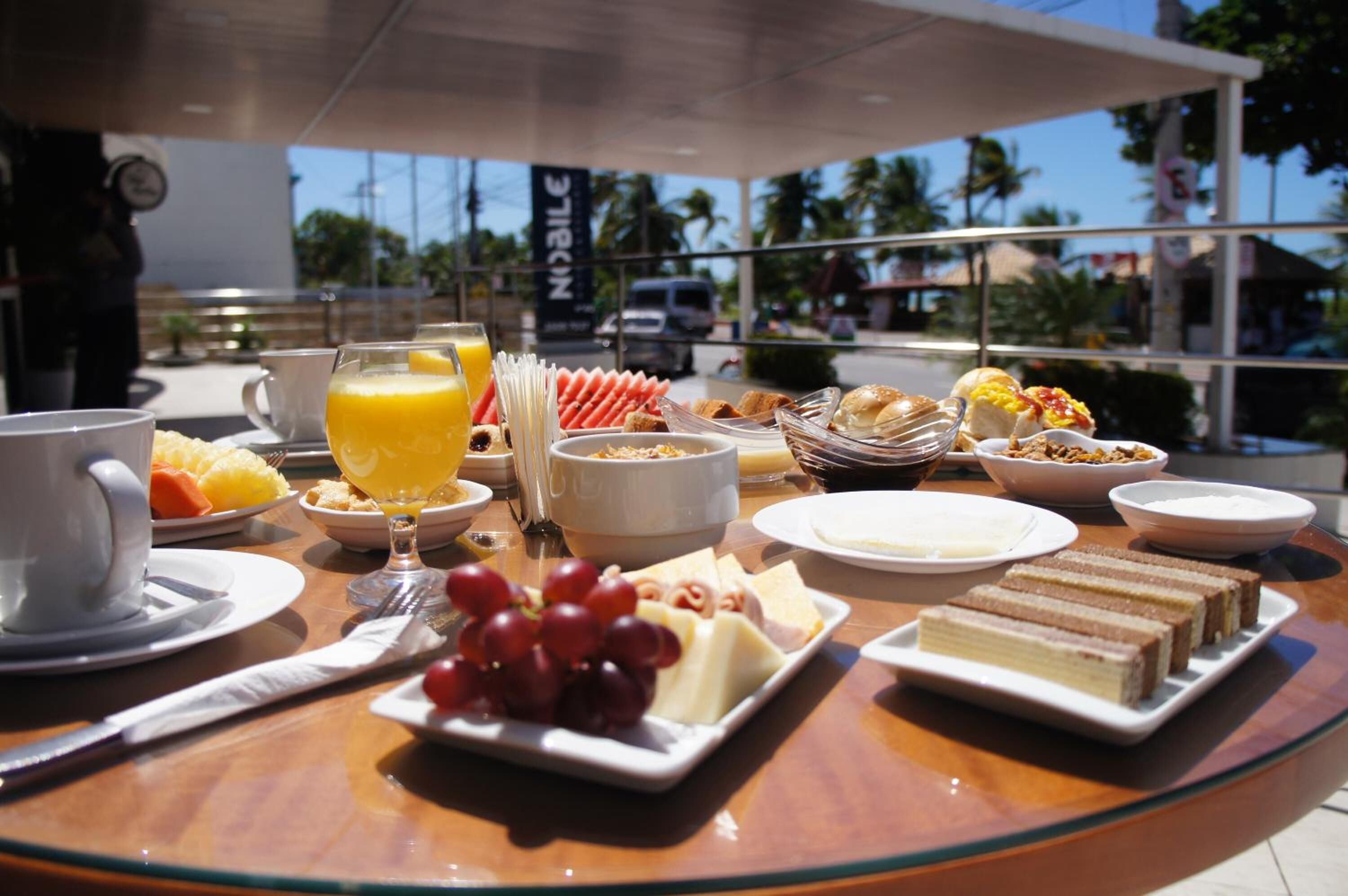 A breakfast table with various food items and a cup of coffee.