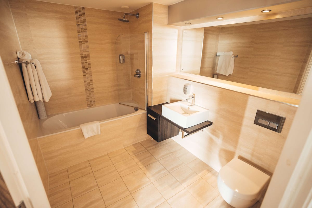 bathtub, free toiletries, hair dryer, towels