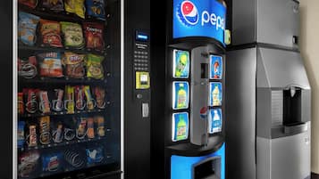 A vending machine with Pepsi branding and a selection of snacks.