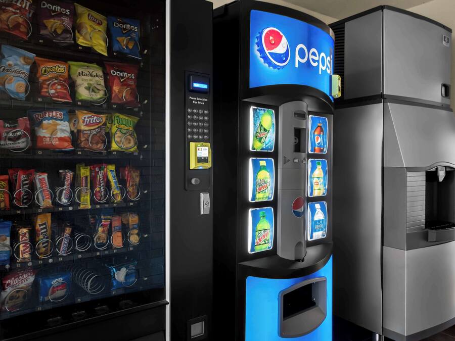 A vending machine with Pepsi branding and a selection of snacks.