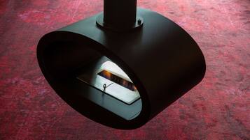 A modern, circular ceiling fixture with a visible light source inside.
