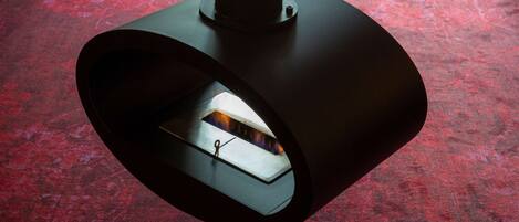 A modern, circular ceiling fixture with a visible light source inside.