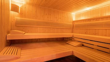 A sauna with wooden benches and benches, a bench with a towel, and a bench with a towel.