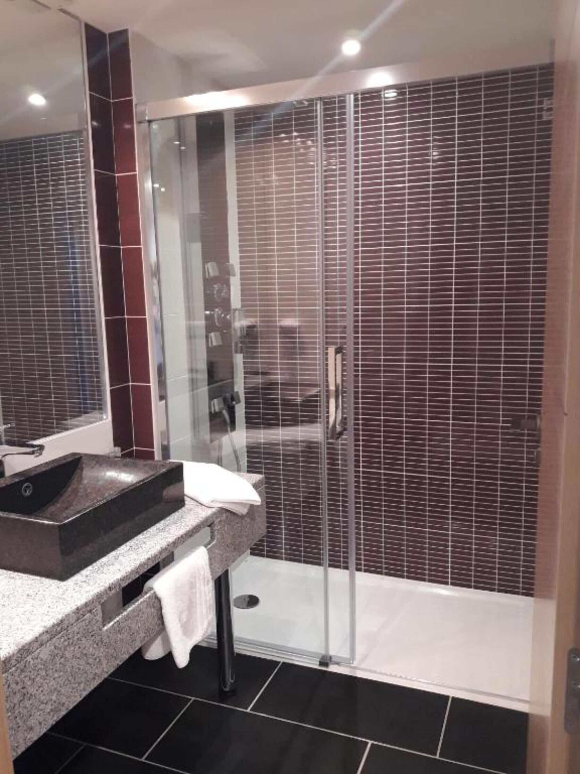 rainfall showerhead, hair dryer, bathrobes, towels