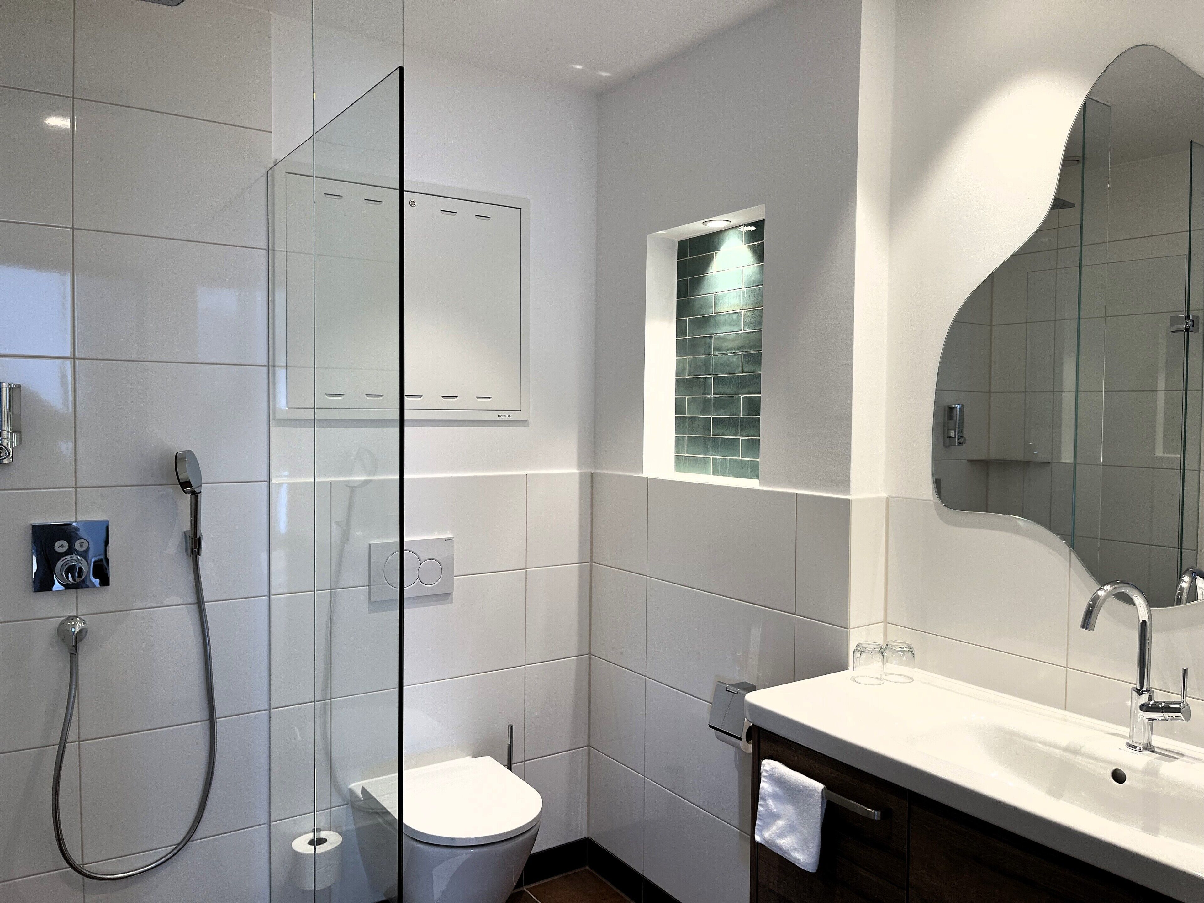 family room | bathroom | shower, rainfall showerhead, hair dryer, towels