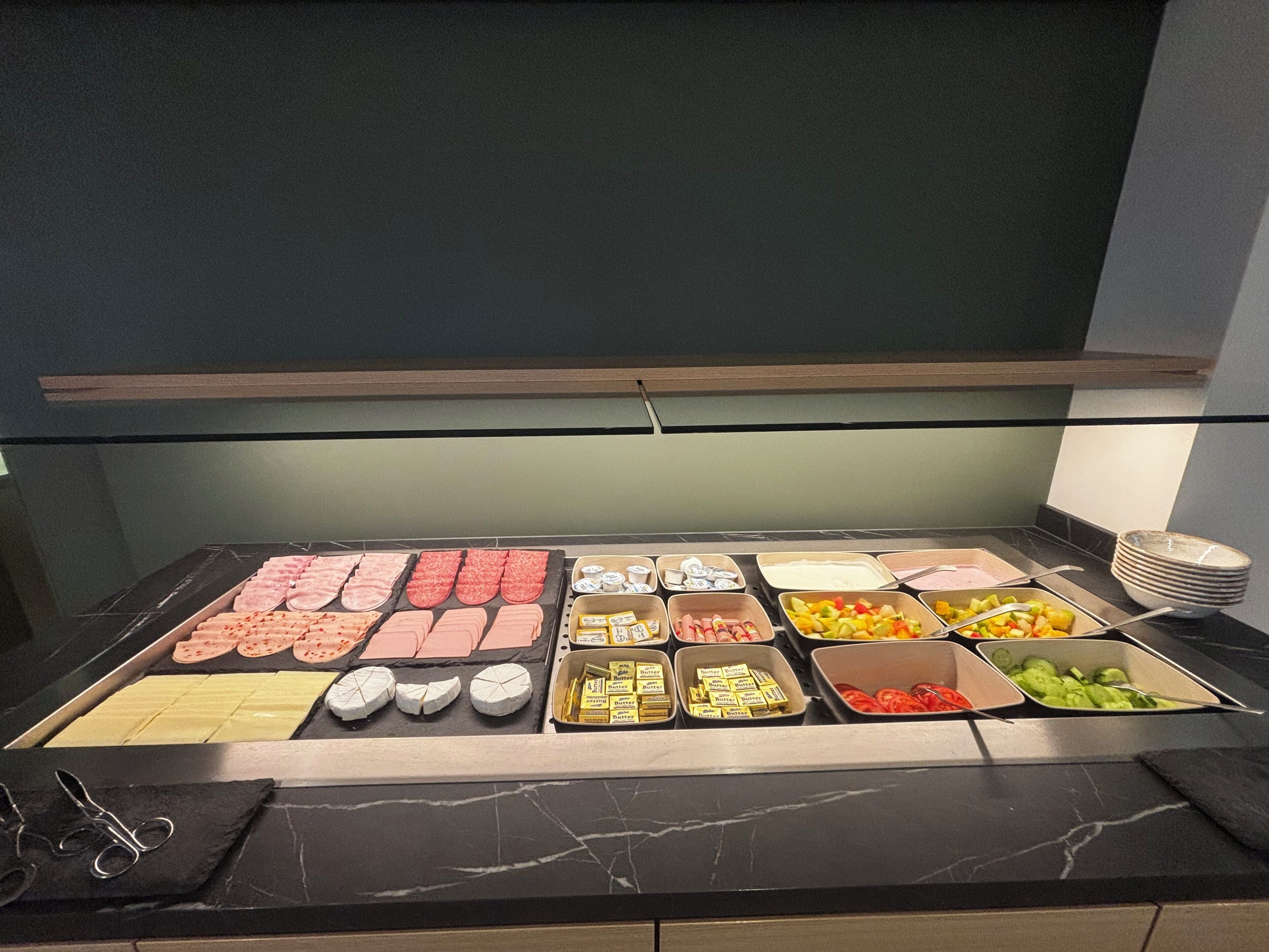 A buffet with various food items and condiments.