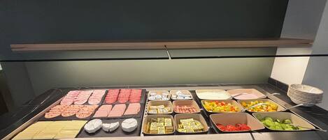 A buffet with various food items and condiments.