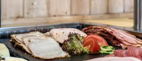 A variety of meats and cheeses on a tray.