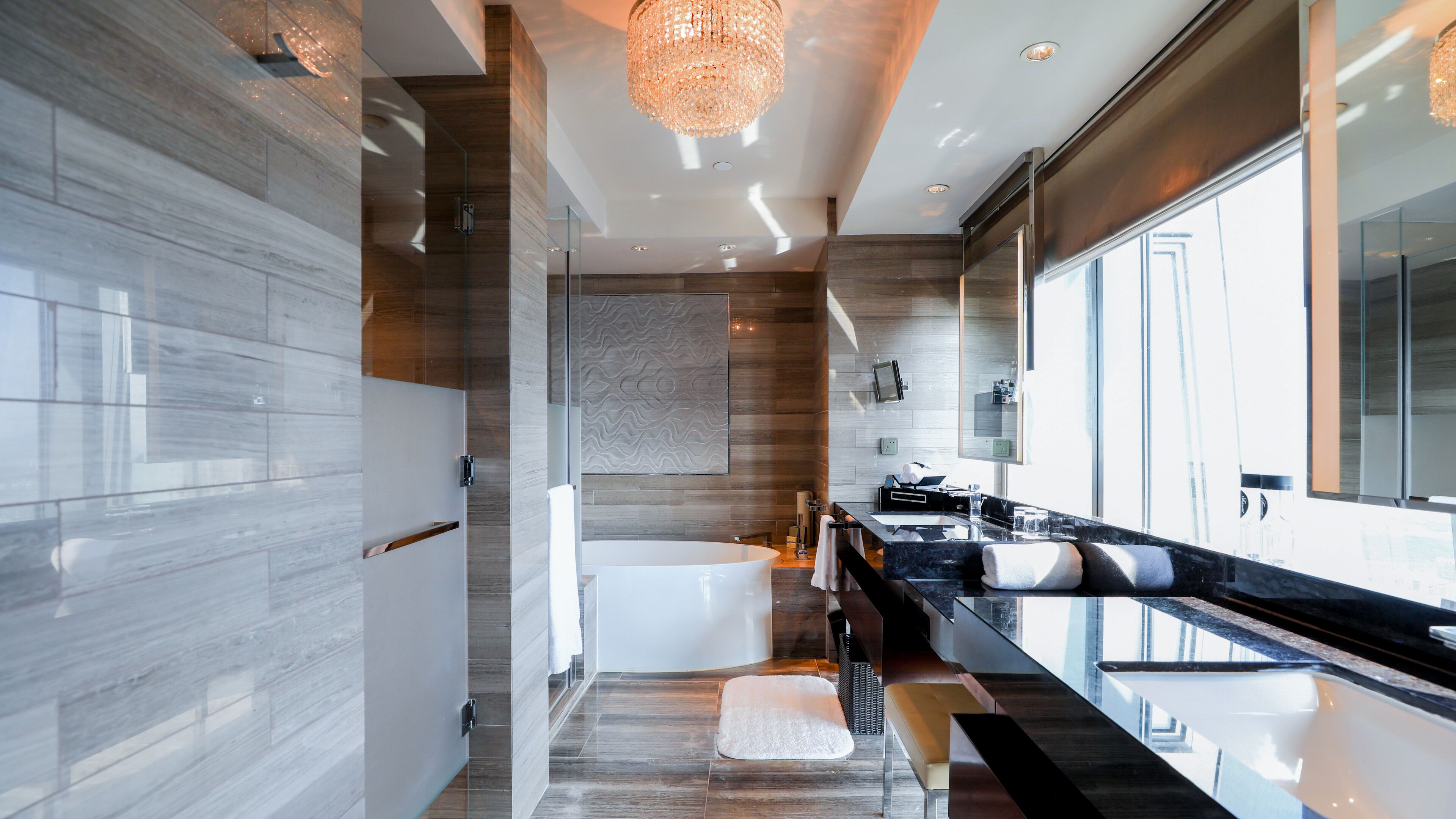 deep-soaking bathtub, rainfall showerhead, designer toiletries