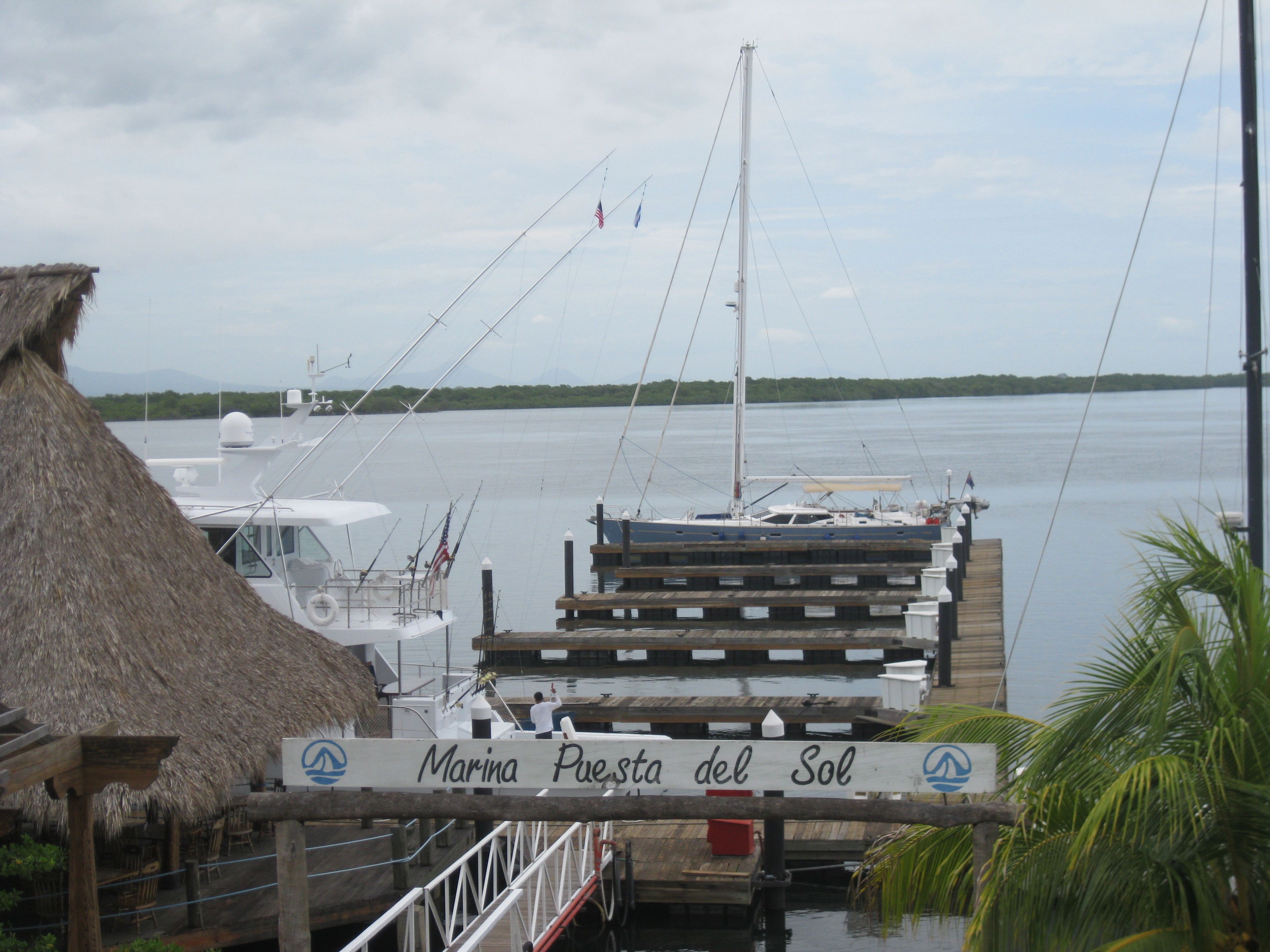 Un port de plaisance doté d’une structure à toit de chaume et d’un quai en bois.