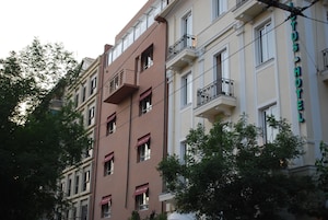 A multi-story hotel with balconies and a sign reading "HOTEL".