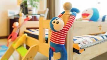 Kids can play on the slide in this cozy room with a comfortable bed and a fun play area.