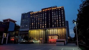 A multi-story hotel with a modern facade, large glass windows, and a prominent entrance. - Intercity Hotel (Baoji)