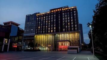 A multi-story hotel with a modern facade, large glass windows, and a prominent entrance.