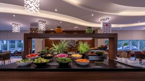 A buffet area with various food options and a selection of bowls and plates. - Ramada Encore by Wyndham Istanbul Bayrampasa (Istanbul)