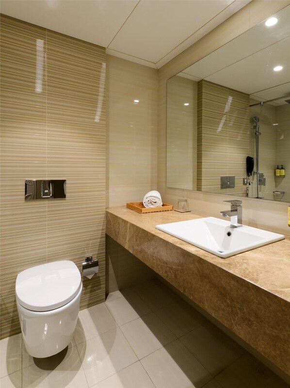 A modern bathroom with a toilet, a sink, and a shower. - Lemon Tree Premier, Sabarmati Riverfront, Ahmedabad (Ahmedabad)