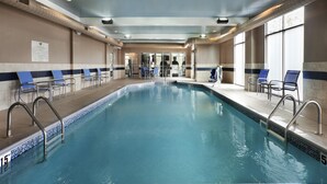 An indoor swimming pool with clear water, surrounded by lounge chairs and a tiled floor. - Homewood Suites by Hilton Columbus/OSU, OH (Columbus)
