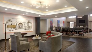 A hotel lobby with a dining area, seating arrangements, and a large artwork on the wall. - Homewood Suites by Hilton Columbus/OSU, OH (Columbus)