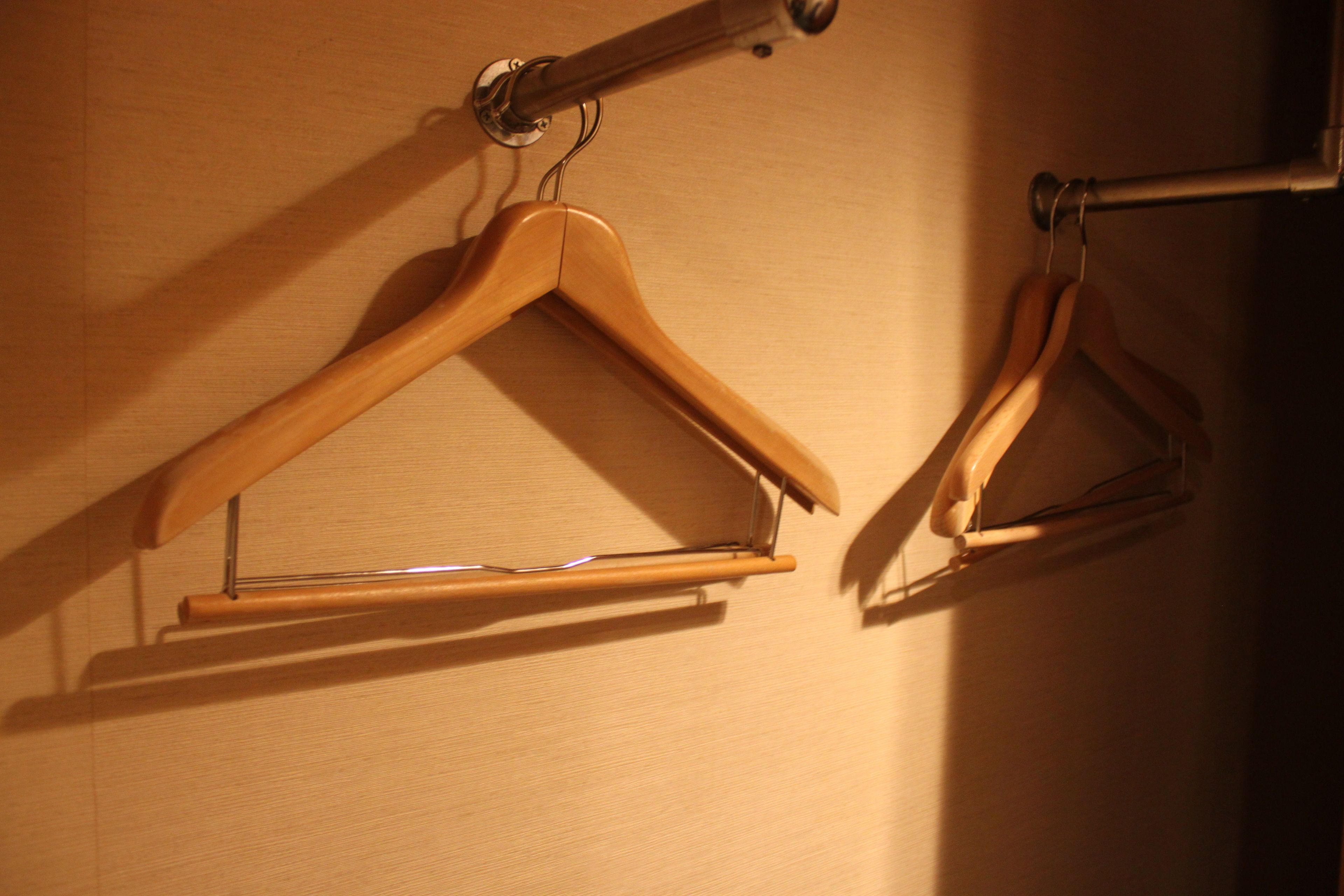 Two wooden hangers on a wall.