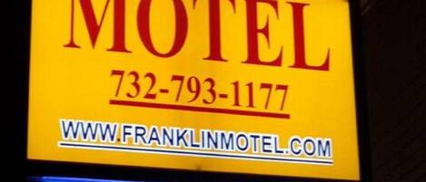 A motel sign with the name 'Franklin Terrace Motel', a phone number, and a website URL.