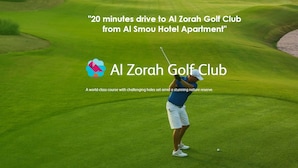 A golf course with a water body nearby. - Al Smou Hotel Apartments (Ajman)