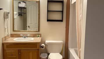 A bathroom with a sink, toilet, and shower curtain.