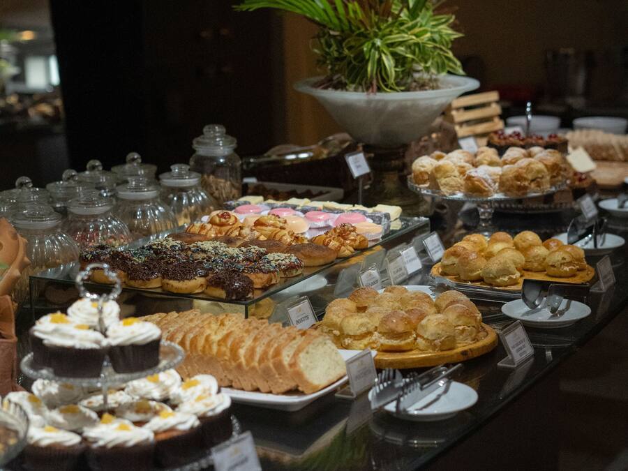 A buffet with various baked goods and desserts.