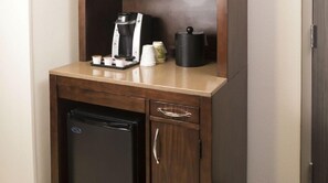 A compact kitchenette with a coffee maker, a small refrigerator, and a cup holder. - Hilton Garden Inn Sioux Falls Downtown (Sioux Falls)