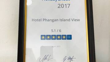 A framed HolidayCheck 2017 award for Hotel Phangan Island View, rated 5.1/6, dated April 2017.
