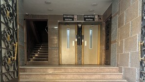 A hotel entrance with two elevators marked "ISIS HOTEL2 15th floor" and a staircase leading to the elevators. - Isis Hostel 2 (Cairo)