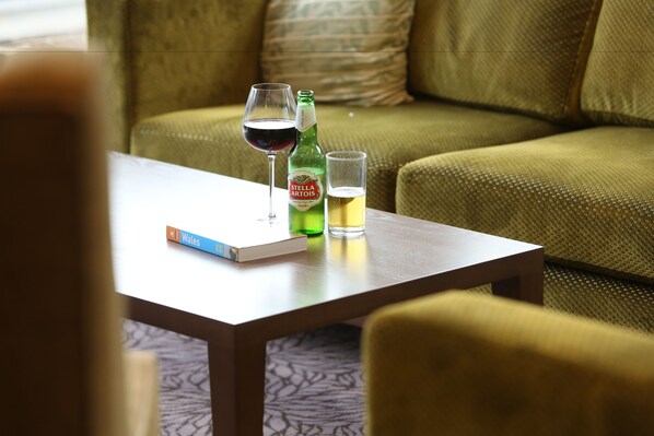A table with a book, a bottle of Stella Artois beer, and a glass of beer.